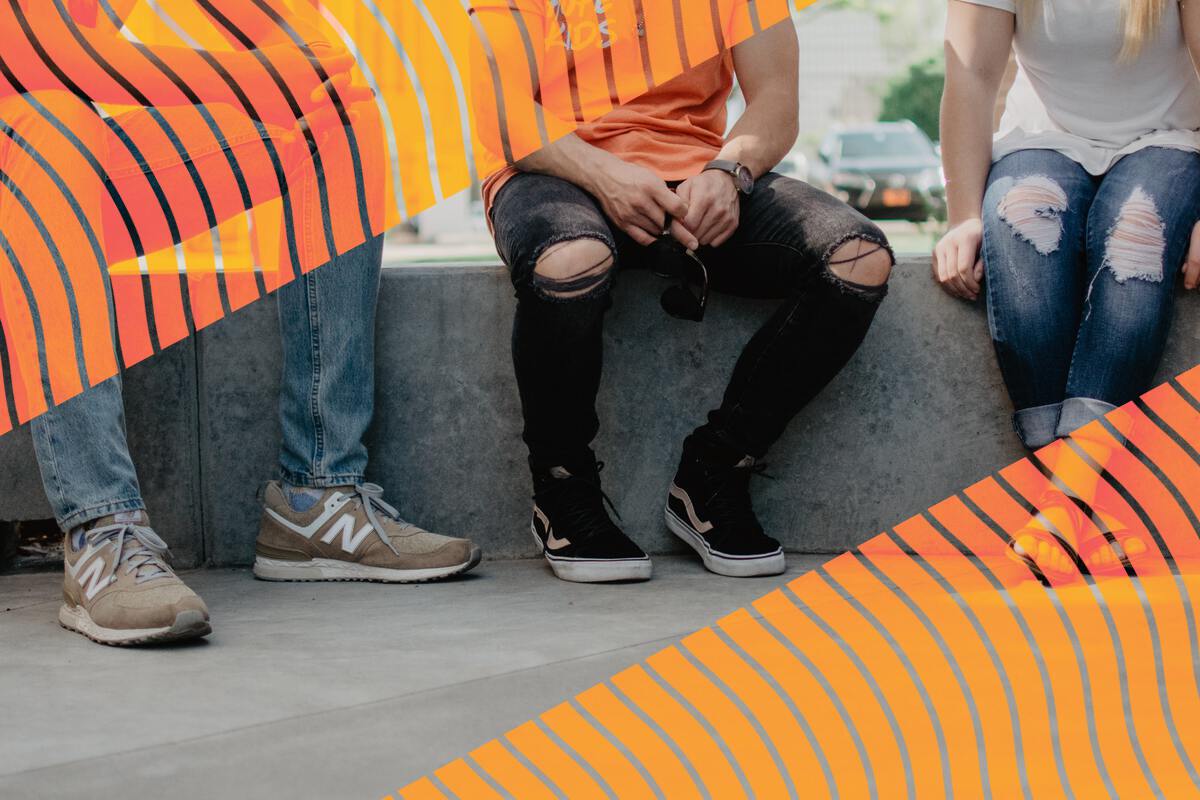 Three students sitting on a wall