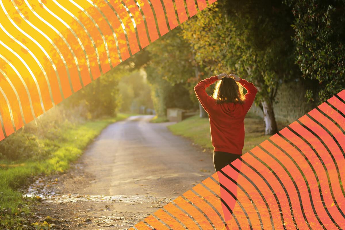 A person walking along a country road